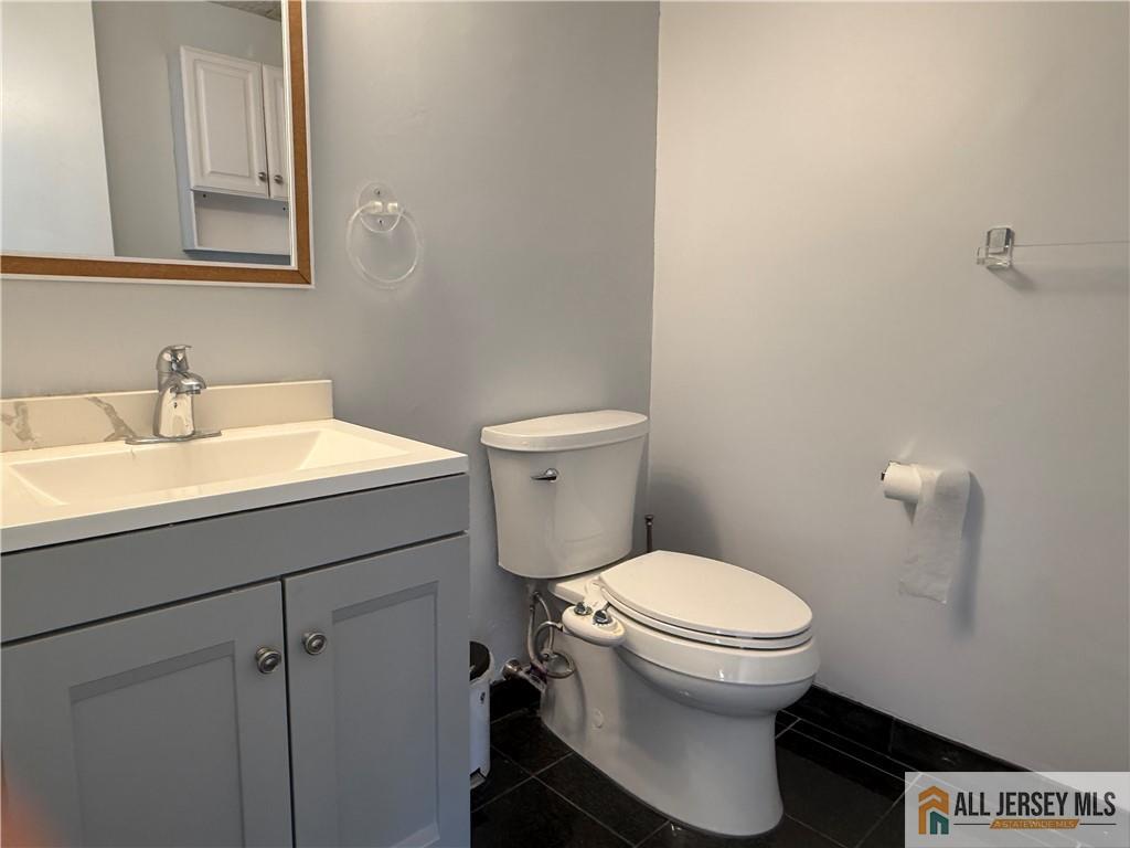 105 Westgate Drive, Unit 105 Edison, NJ 08820 - Photo 16 of 28 a bathroom with a sink toilet and a mirror