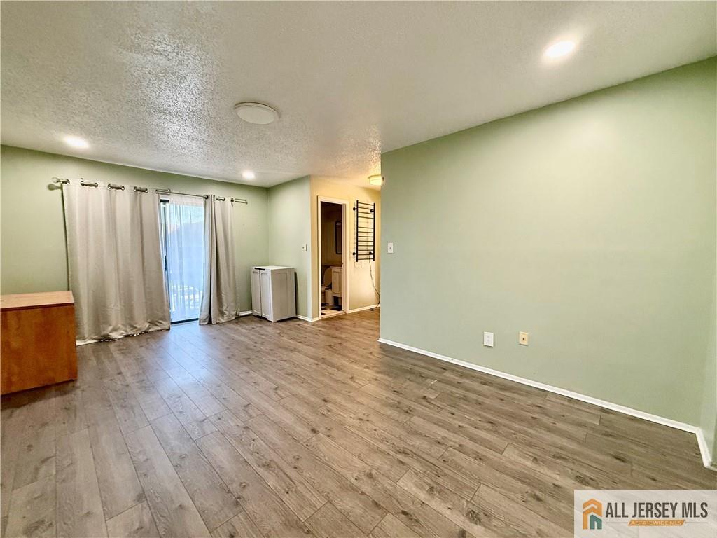 105 Westgate Drive, Unit 105 Edison, NJ 08820 - Photo 19 of 28 an empty room with wooden floor and closet area