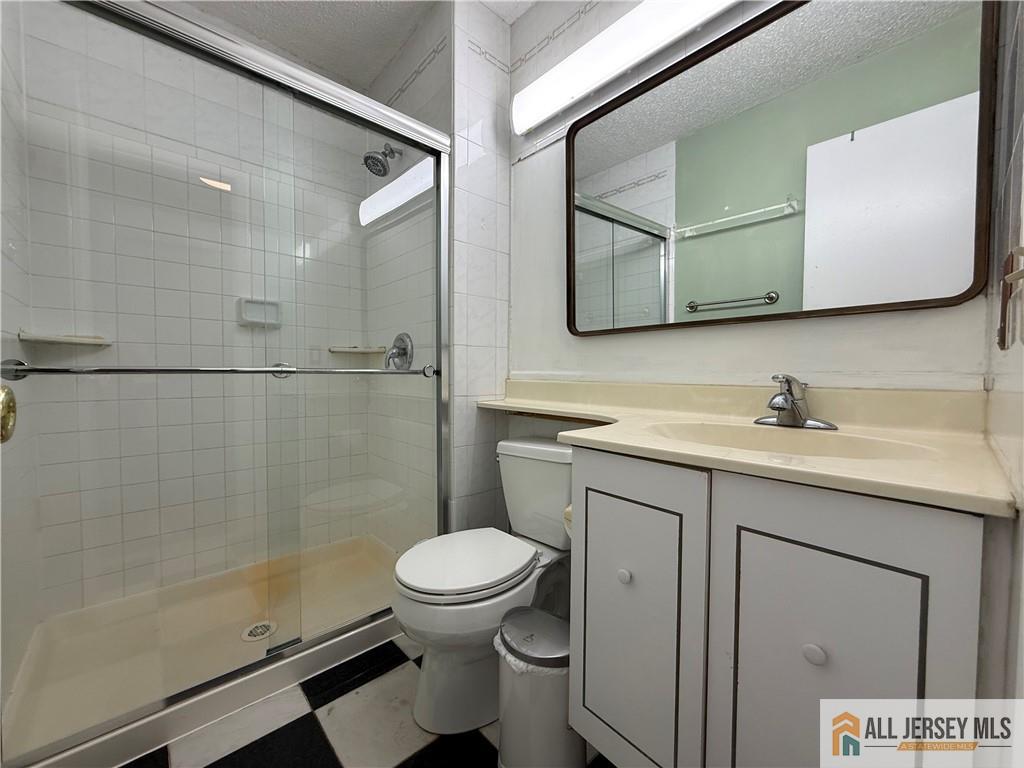 105 Westgate Drive, Unit 105 Edison, NJ 08820 - Photo 20 of 28 a bathroom with a granite countertop sink toilet and shower