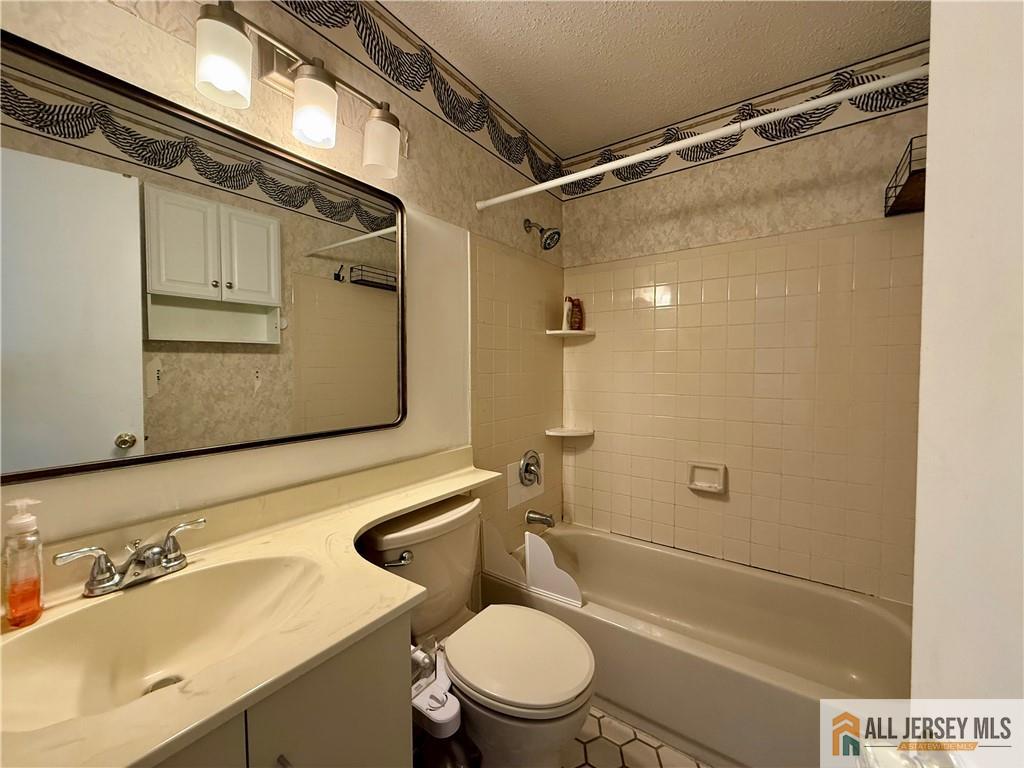 105 Westgate Drive, Unit 105 Edison, NJ 08820 - Photo 22 of 28 a bathroom with a sink a toilet and shower
