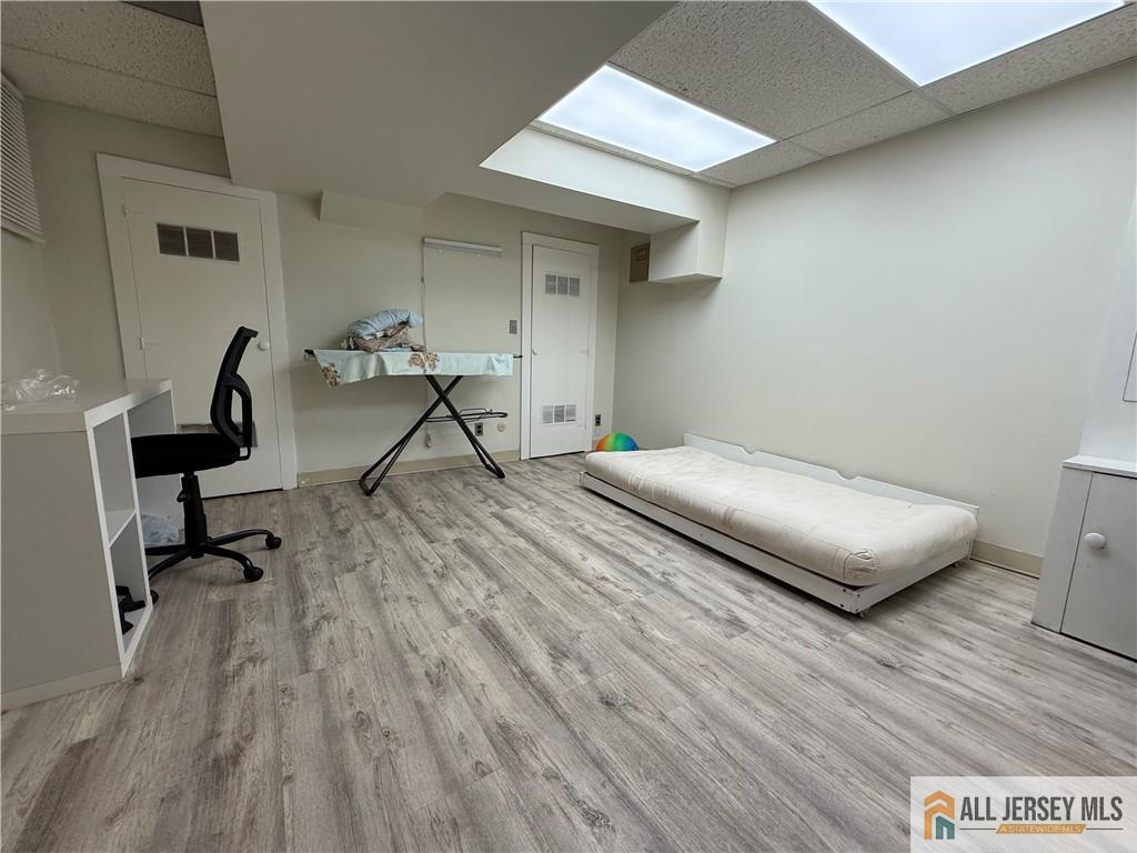 105 Westgate Drive, Unit 105 Edison, NJ 08820 - Photo 24 of 28 a bedroom with a bed and a desk