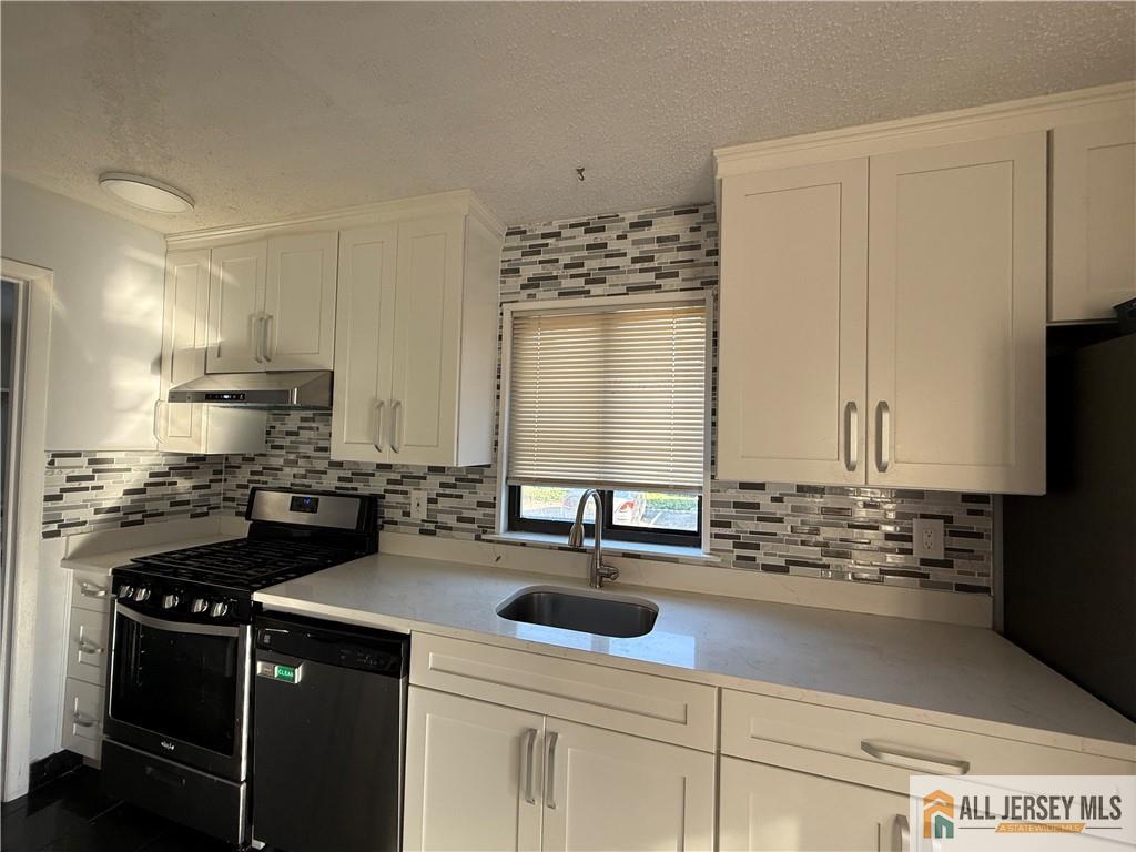 105 Westgate Drive, Unit 105 Edison, NJ 08820 - Photo 7 of 28 a kitchen with sink a stove and cabinets