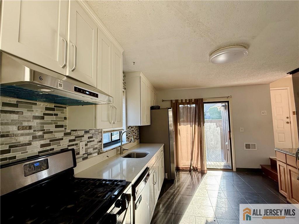 105 Westgate Drive, Unit 105 Edison, NJ 08820 - Photo 9 of 28 a kitchen with stainless steel appliances granite countertop a sink stove and refrigerator