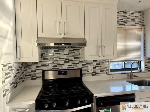 105 Westgate Drive, Unit 105 Edison, NJ 08820 - Photo 10 of 28 a kitchen with stainless steel appliances a stove a sink and a microwave