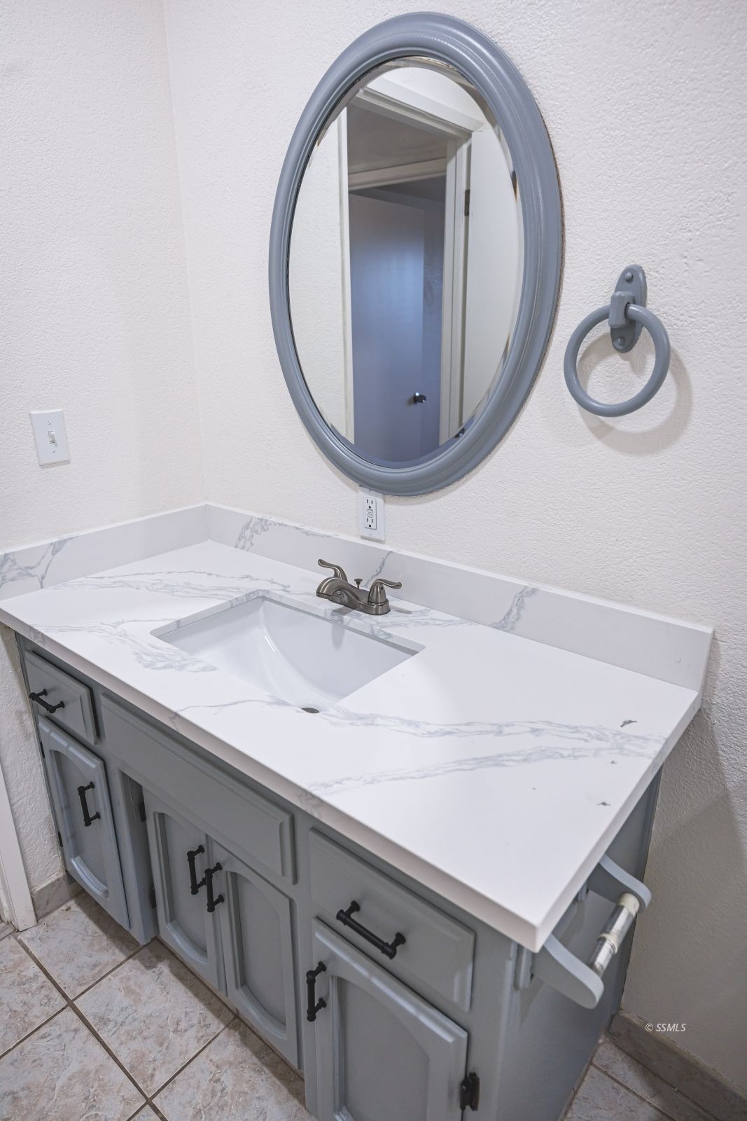 1213 Primrose Street Ridgecrest, CA 93555 - Photo 14 of 37 a bathroom with a sink a vanity and a mirror