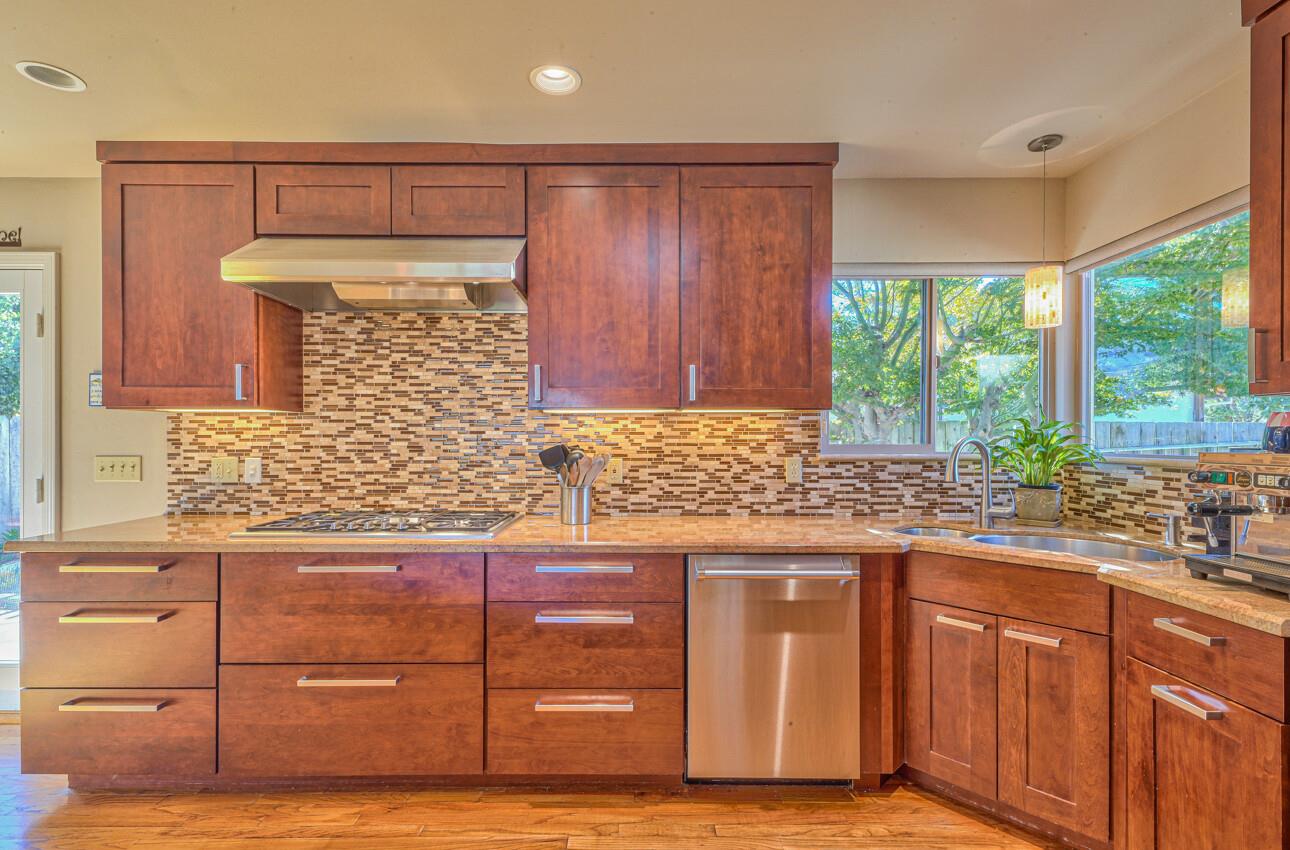 118 Enos Drive Salinas, CA 93908 - Photo 18 of 59 a kitchen with granite countertop wooden cabinets and a sink