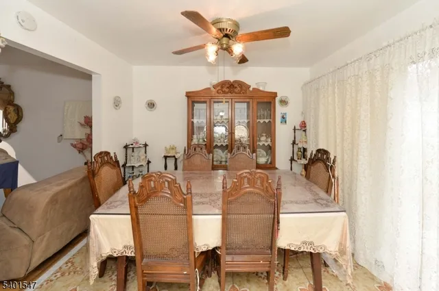 a view of a dining room with furniture and a chandelier