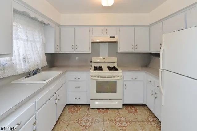 a kitchen with cabinets appliances and a sink