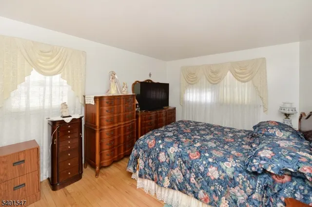 a bedroom with a bed and flat screen tv