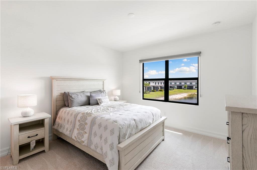 7572 Carnegie Way Naples, FL 34119 - Photo 20 of 43 a bedroom with a bed and a window