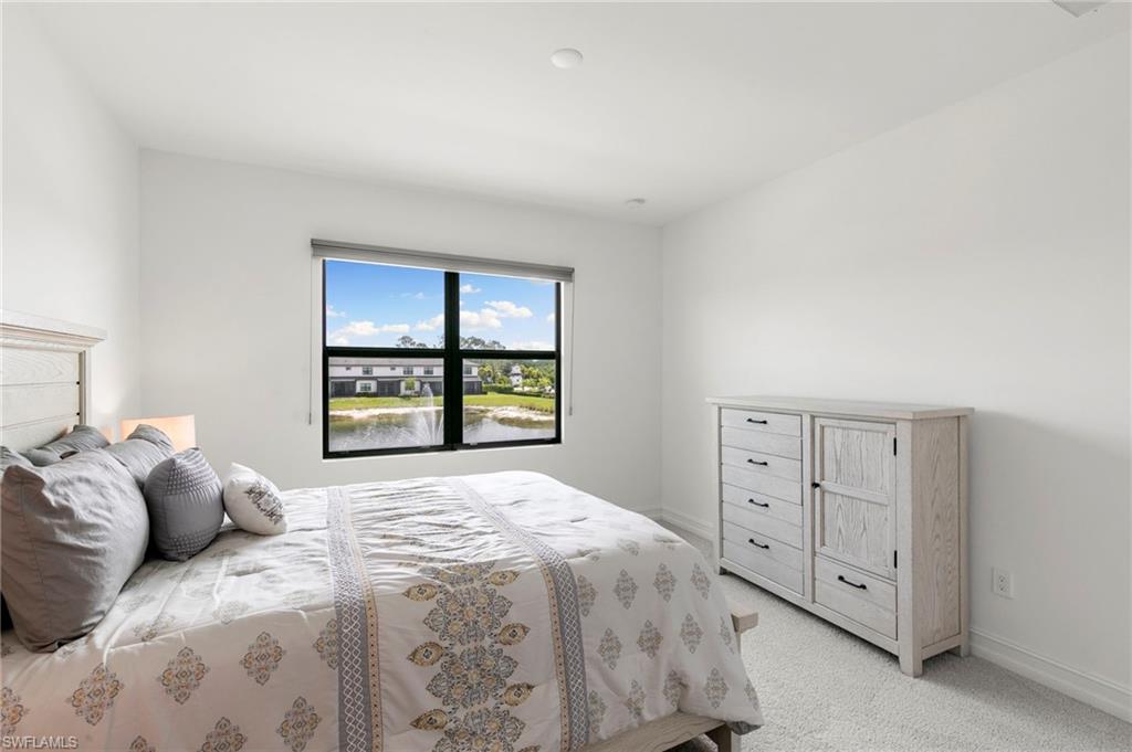 7572 Carnegie Way Naples, FL 34119 - Photo 21 of 43 a bedroom with a bed and a window