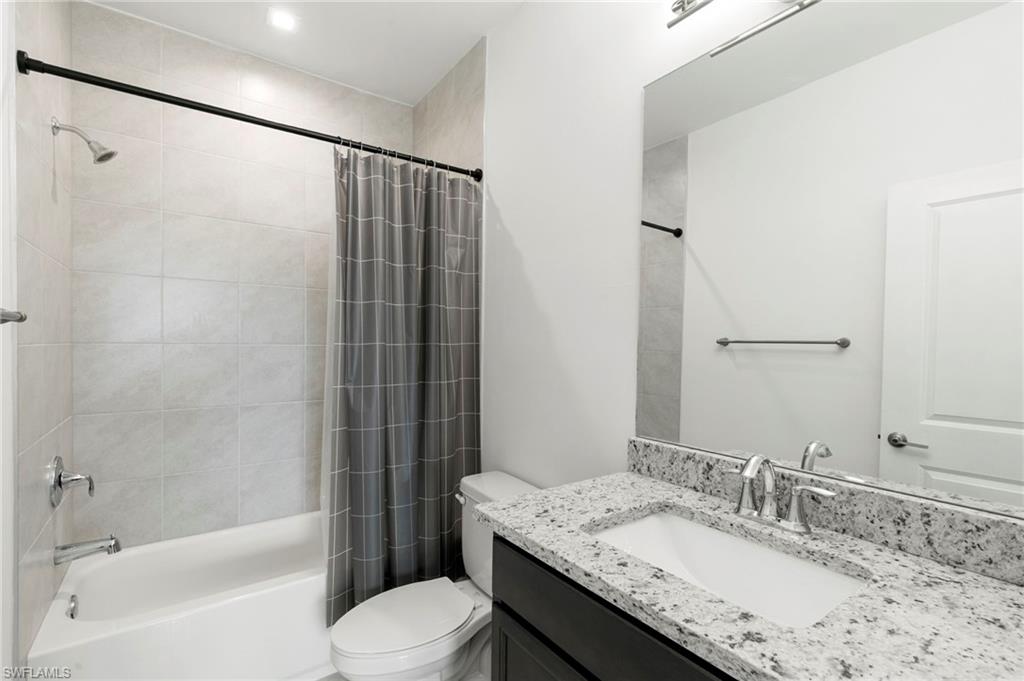 7572 Carnegie Way Naples, FL 34119 - Photo 22 of 43 a bathroom with a granite countertop sink toilet and shower
