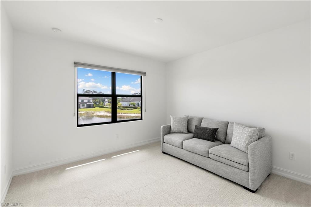7572 Carnegie Way Naples, FL 34119 - Photo 23 of 43 a living room with furniture and a window