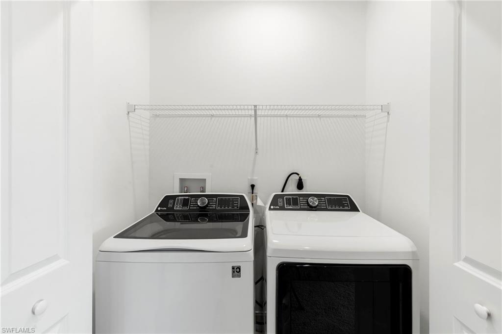 7572 Carnegie Way Naples, FL 34119 - Photo 28 of 43 a utility room with dryer and washer