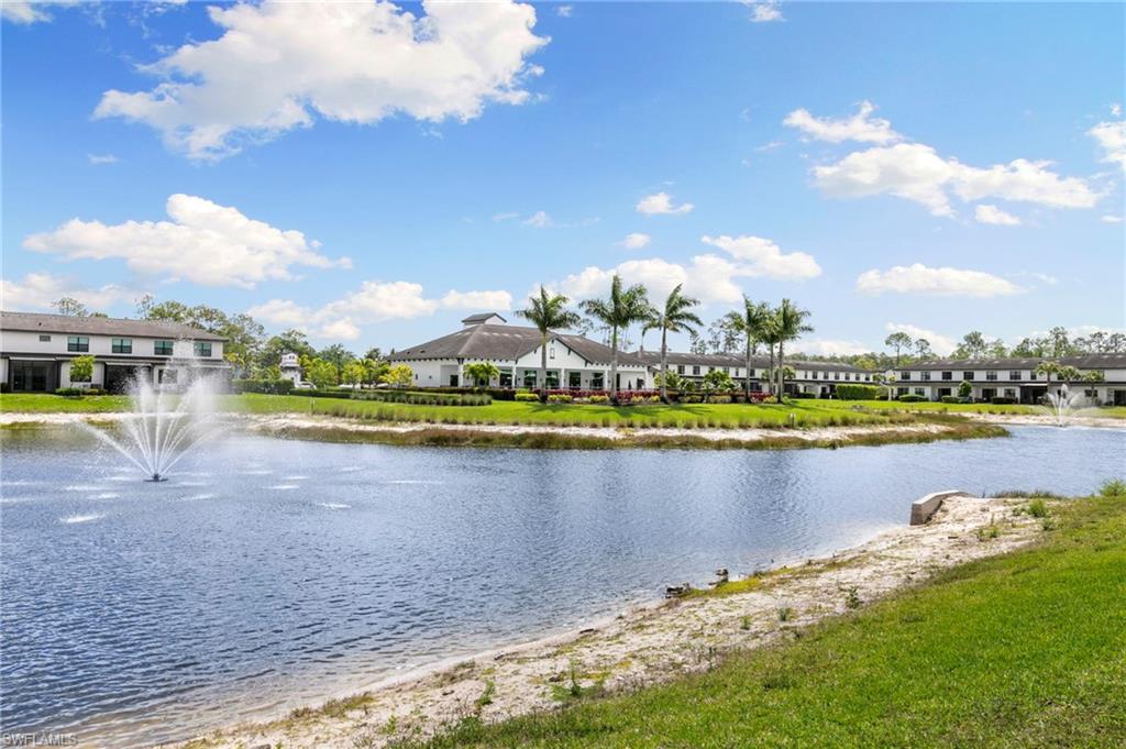 7572 Carnegie Way Naples, FL 34119 - Photo 32 of 43 a view of a lake with a house in the background