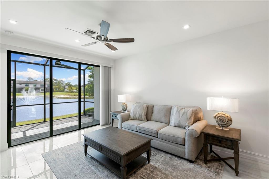 7572 Carnegie Way Naples, FL 34119 - Photo 8 of 43 a living room with furniture and a large window