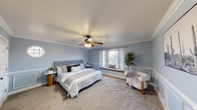 9029 North Treasureton Road Preston, ID 83263 - Photo 9 of 31 Bedroom with a decorative wall, wainscoting, light colored carpet, ornamental molding, and a ceiling fan