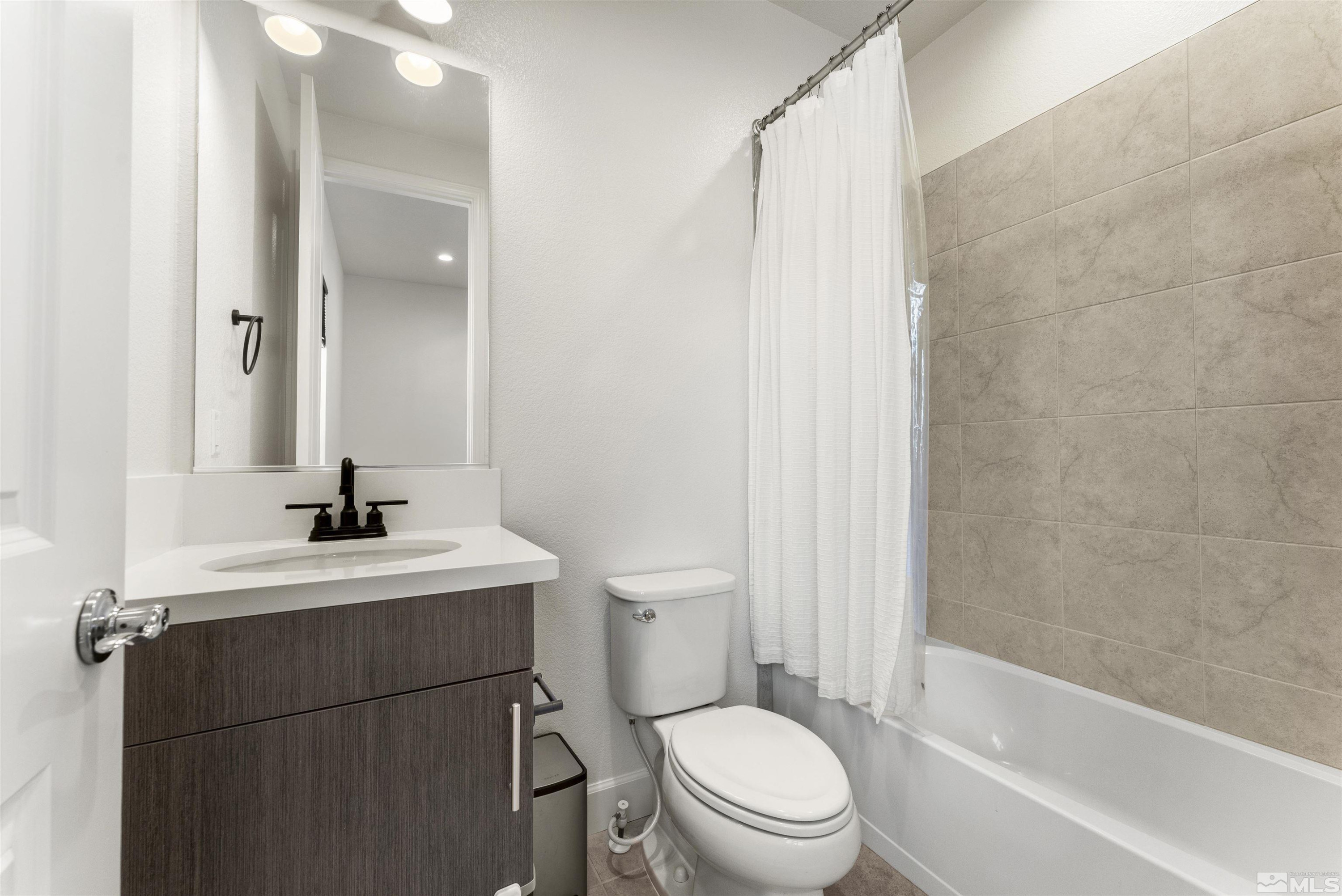 5421 Phillipa Drive Reno, NV 89511 - Photo 19 of 39 a bathroom with a sink toilet vanity and shower