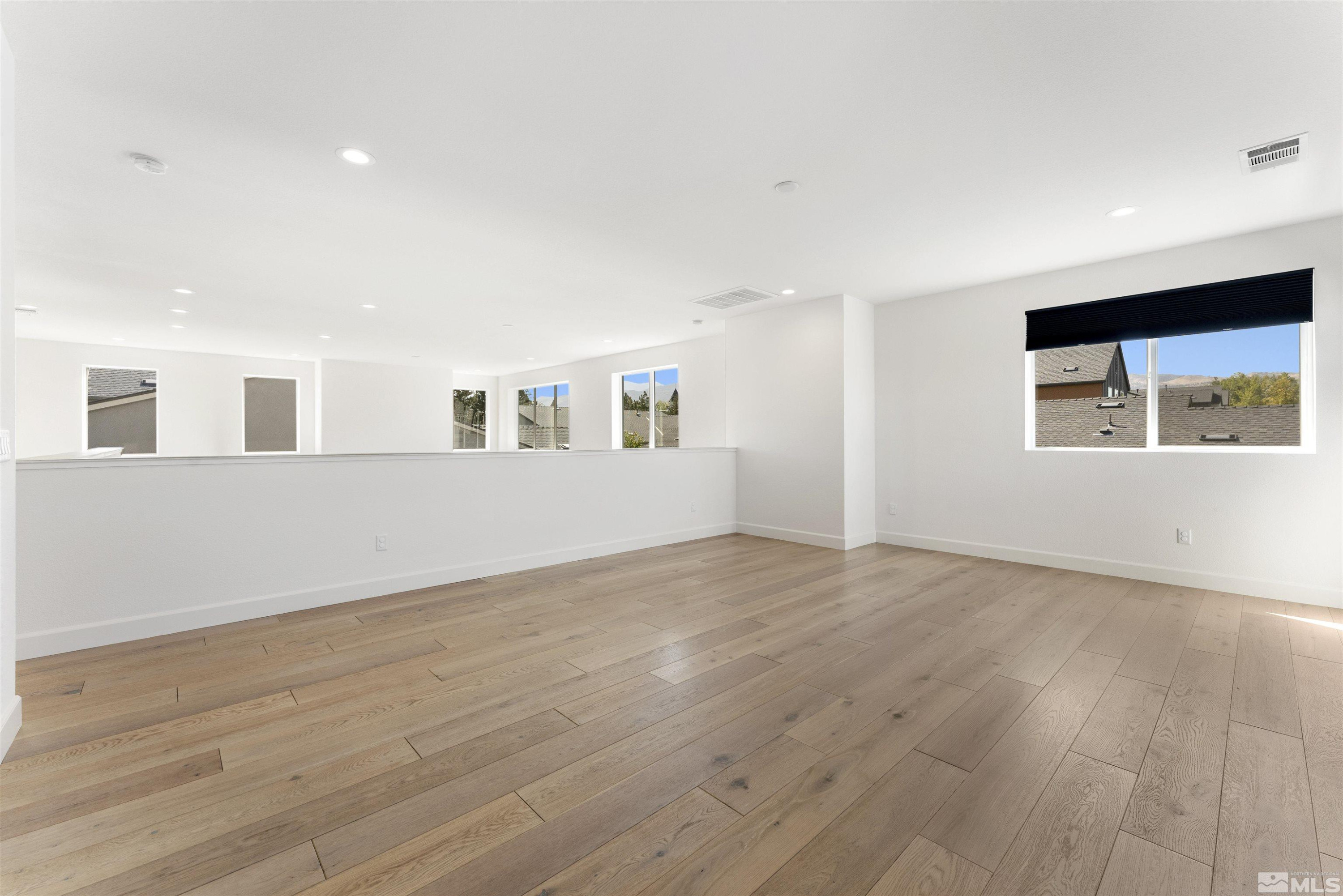 5421 Phillipa Drive Reno, NV 89511 - Photo 22 of 39 a view of an empty room with wooden floor and a window