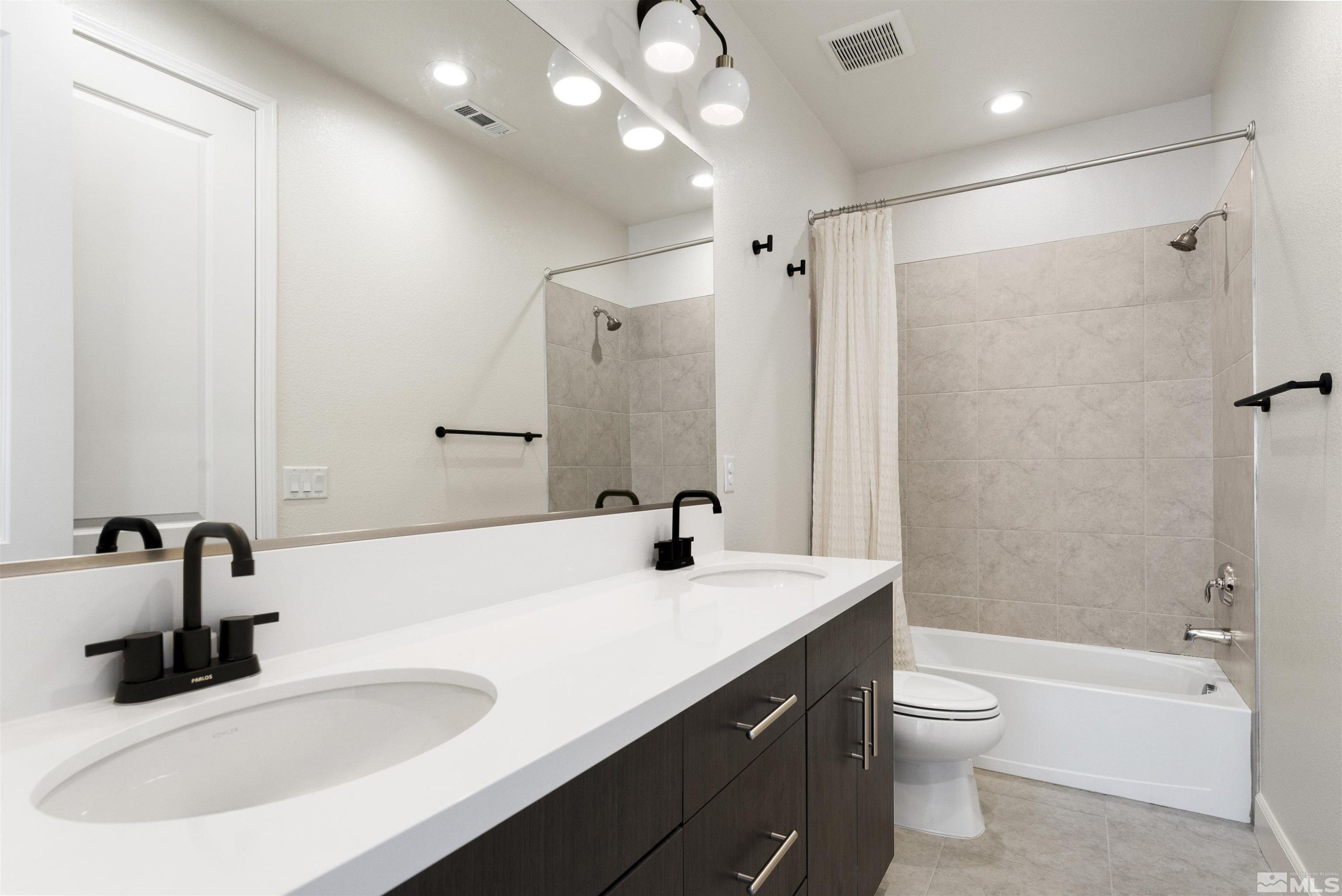 5421 Phillipa Drive Reno, NV 89511 - Photo 25 of 39 a bathroom with a double vanity sink a toilet and shower