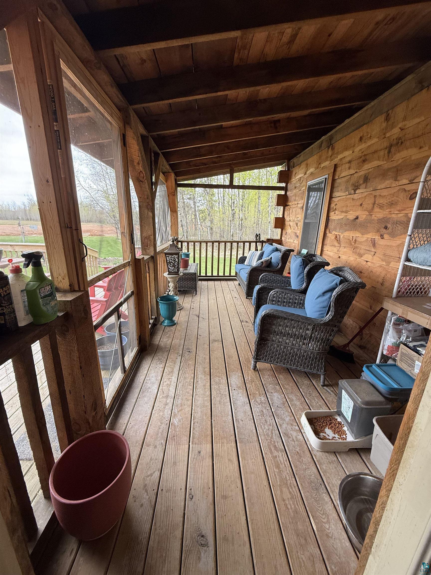 37590 Degerstrom Road Askov, MN 55704 - Photo 33 of 53 Expansive screened porch featuring wood-finish flooring, exposed wood beam ceiling, and wood-paneled walls