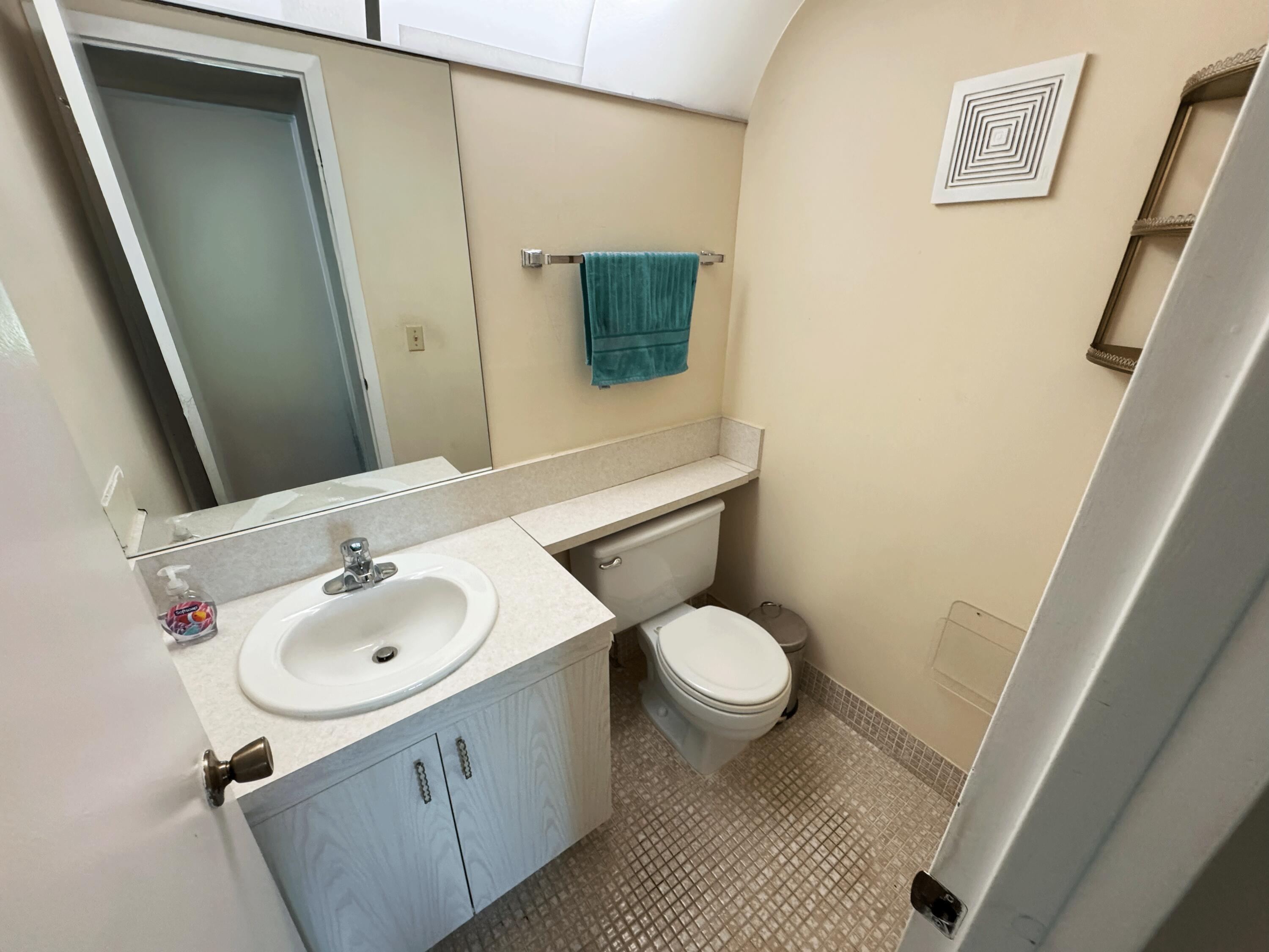 4075 Cornwall East Boca Raton, FL 33434 - Photo 8 of 30 a bathroom with a sink and a mirror