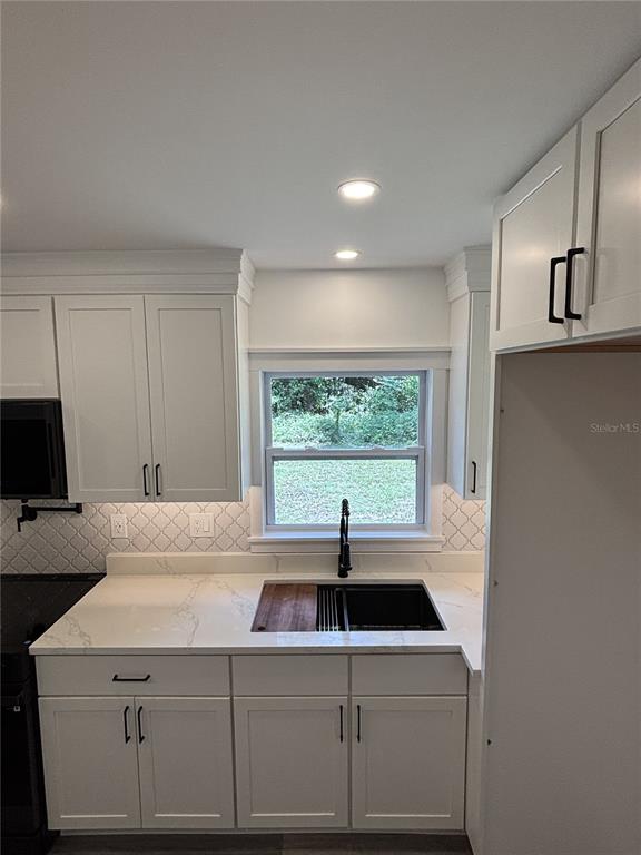 2911 Williams Road Plant City, FL 33565 - Photo 17 of 51 a view of a kitchen with a sink and large window