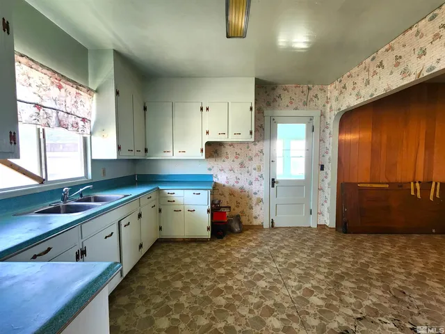 a kitchen that has a sink and a stove in it