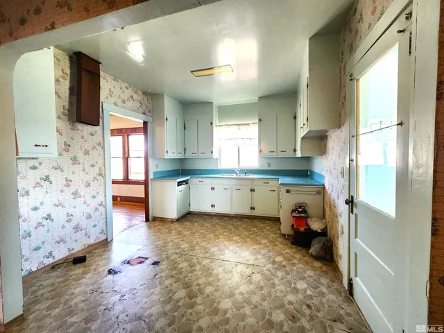 a kitchen with granite countertop a sink a window and stainless steel appliances