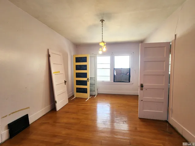 a view of a room with a fireplace and wooden floor