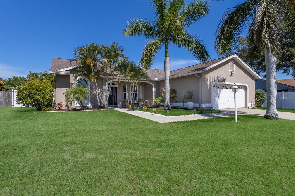 9411 71st Avenue East Palmetto, FL 34221 - Photo 1 of 1 a front view of house with yard and outdoor seating