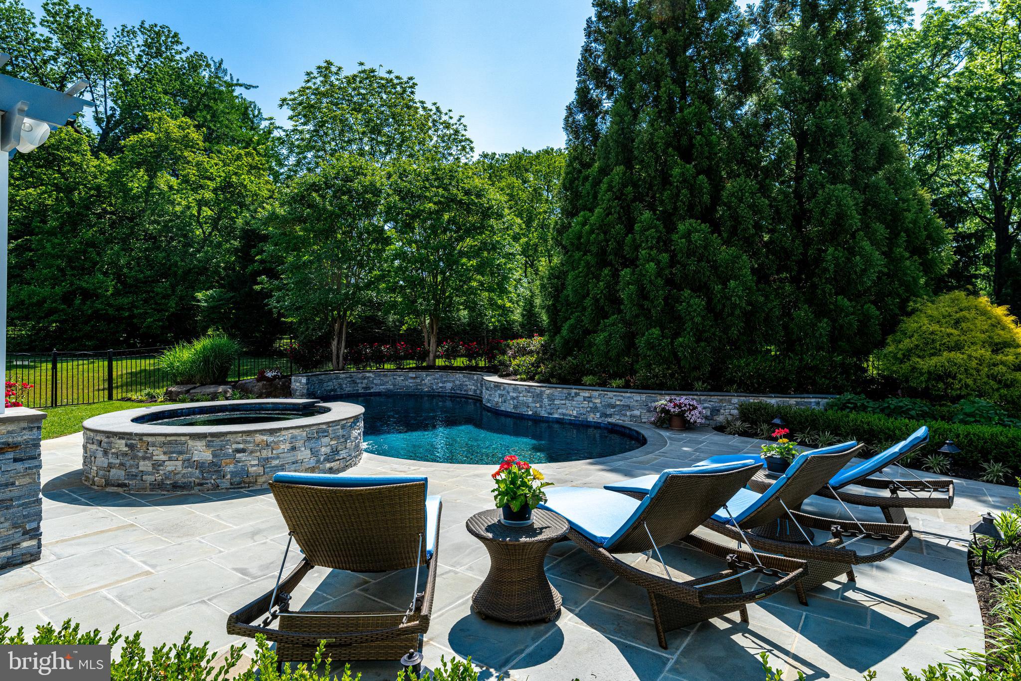 318 Winfield Road Devon, PA 19333 - Photo 30 of 97 a view of a swimming pool with chairs and a fire pit