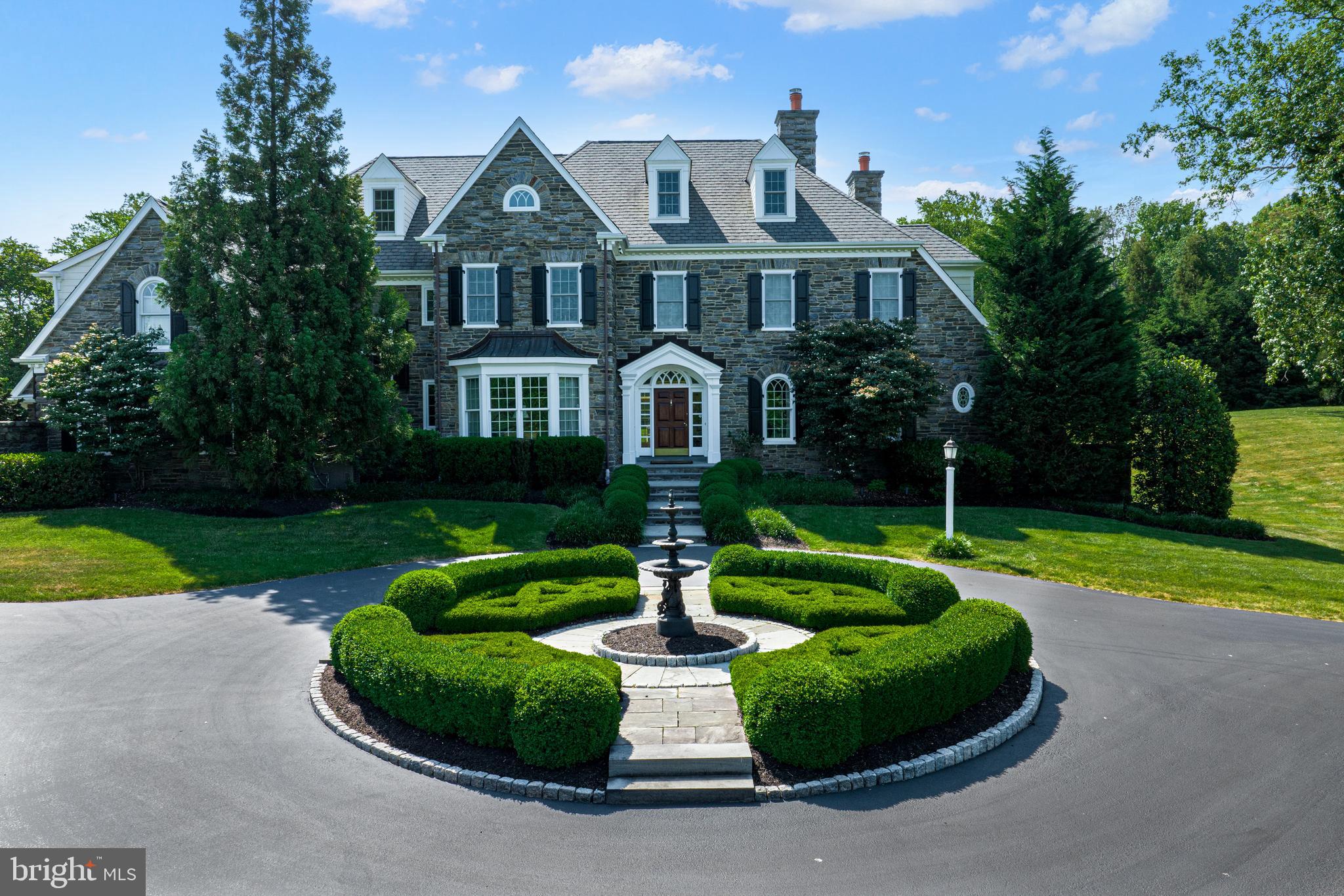 318 Winfield Road Devon, PA 19333 - Photo 34 of 97 a front view of a house with garden and trees