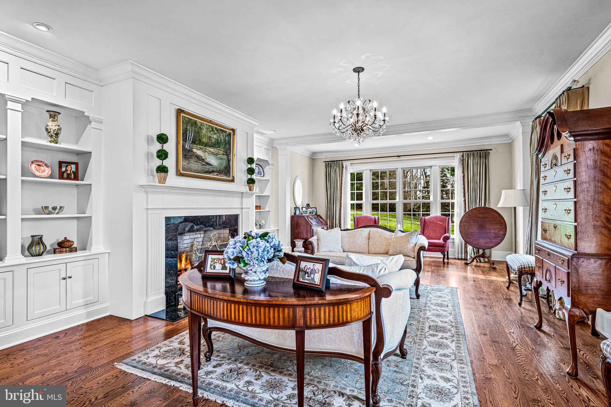 318 Winfield Road Devon, PA 19333 - Photo 41 of 97 a living room with furniture a chandelier and a fireplace