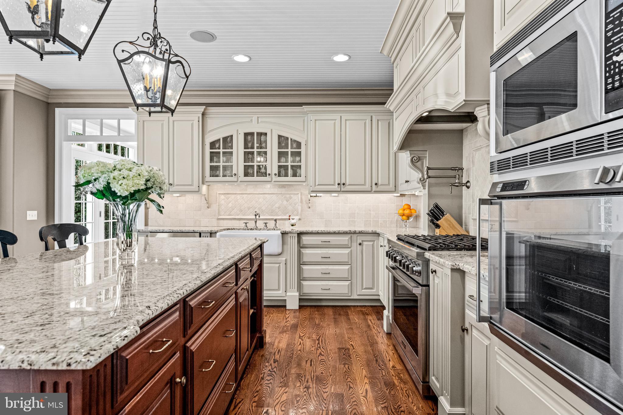 318 Winfield Road Devon, PA 19333 - Photo 47 of 97 a kitchen with stainless steel appliances granite countertop a sink dishwasher stove and oven with wooden floor