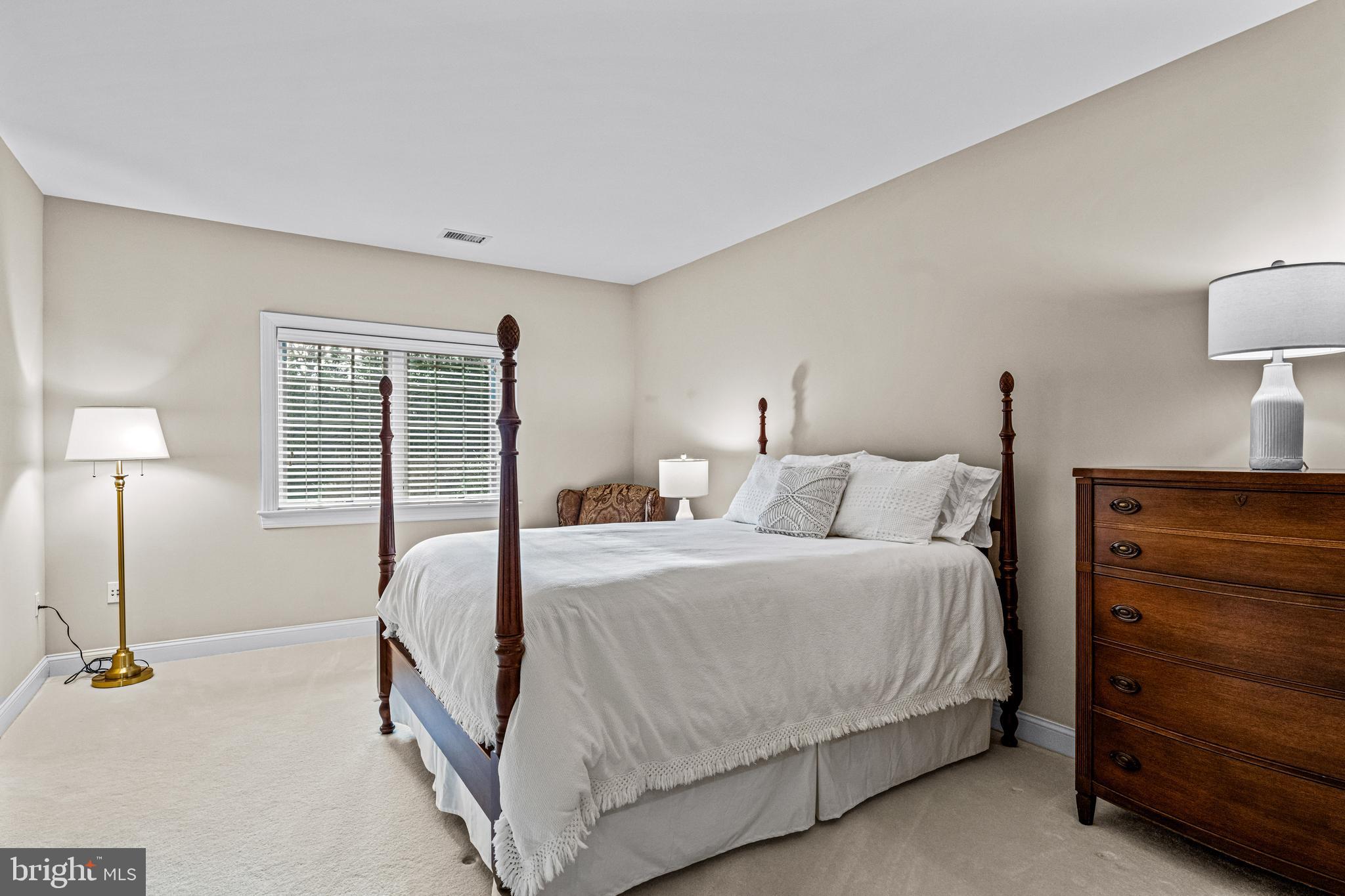 318 Winfield Road Devon, PA 19333 - Photo 79 of 97 a bedroom with a bed and a lamp on dresser