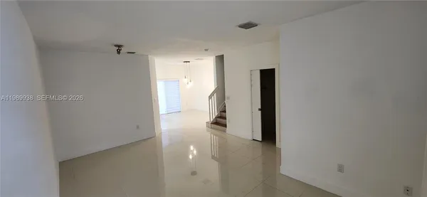 a view of an empty room with stairs