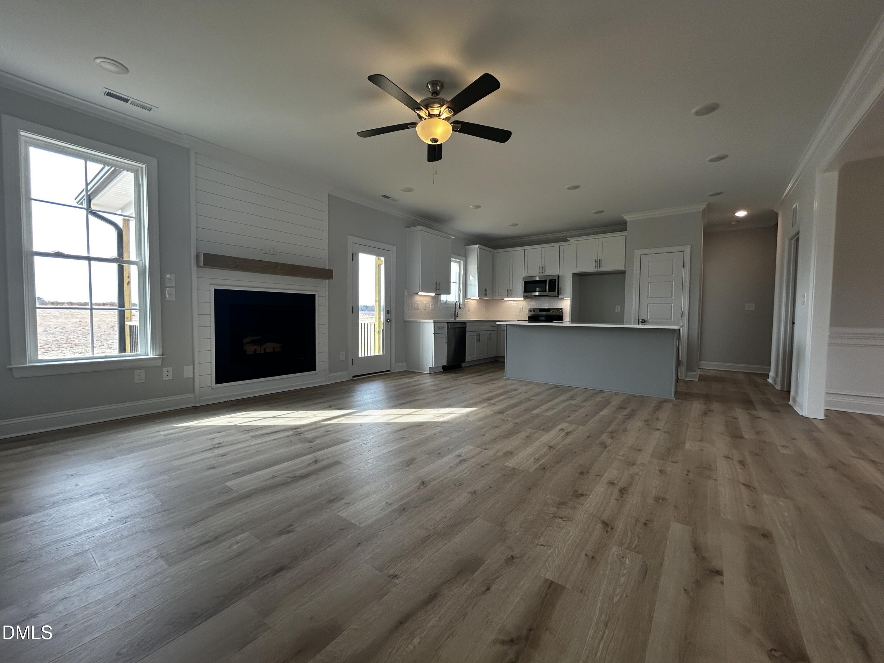 5495 Finch Road Bailey, NC 27880 - Photo 11 of 32 a view of empty room with wooden floor and fireplace