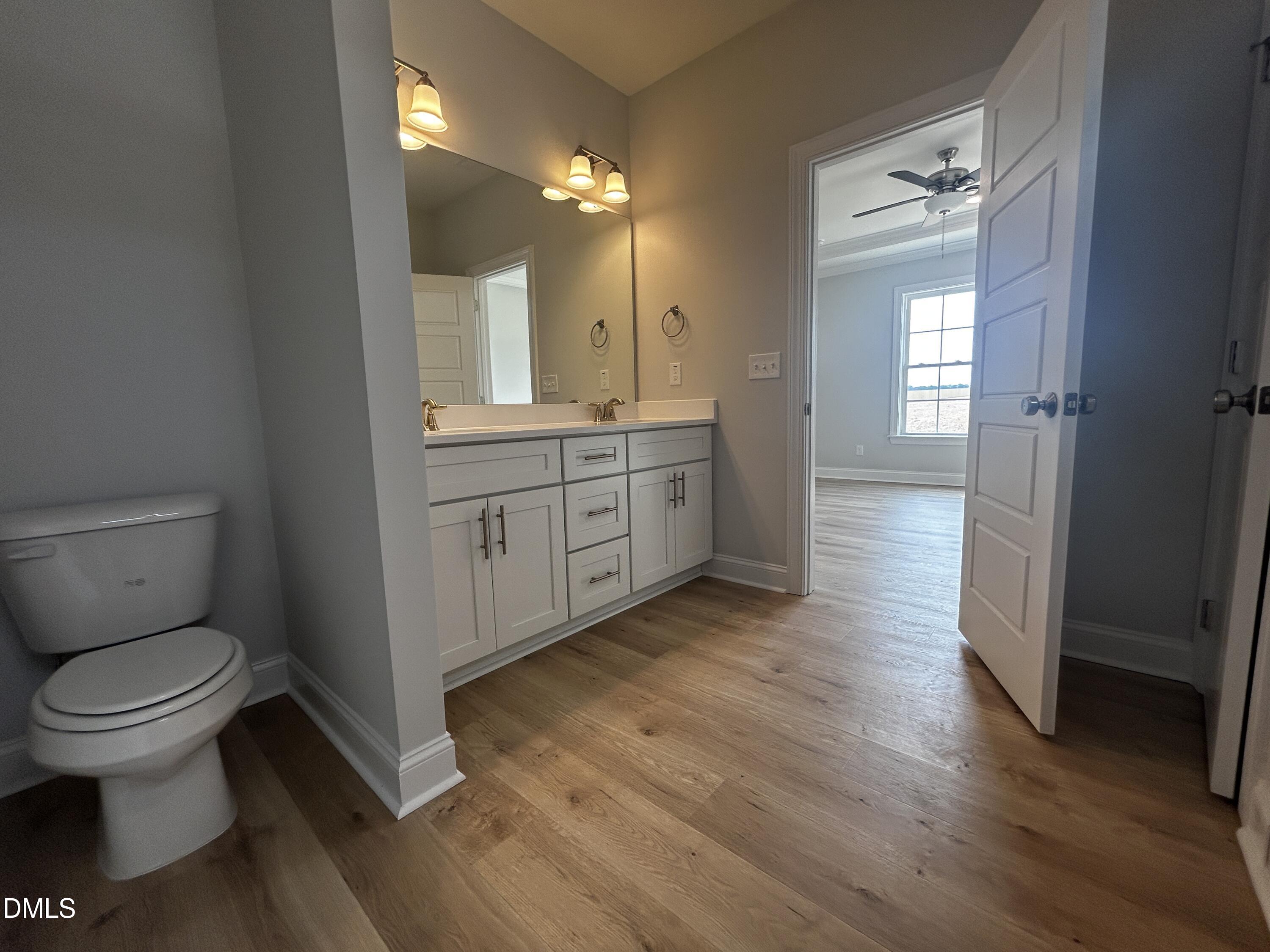 5495 Finch Road Bailey, NC 27880 - Photo 18 of 32 a bathroom with a granite countertop toilet sink and mirror