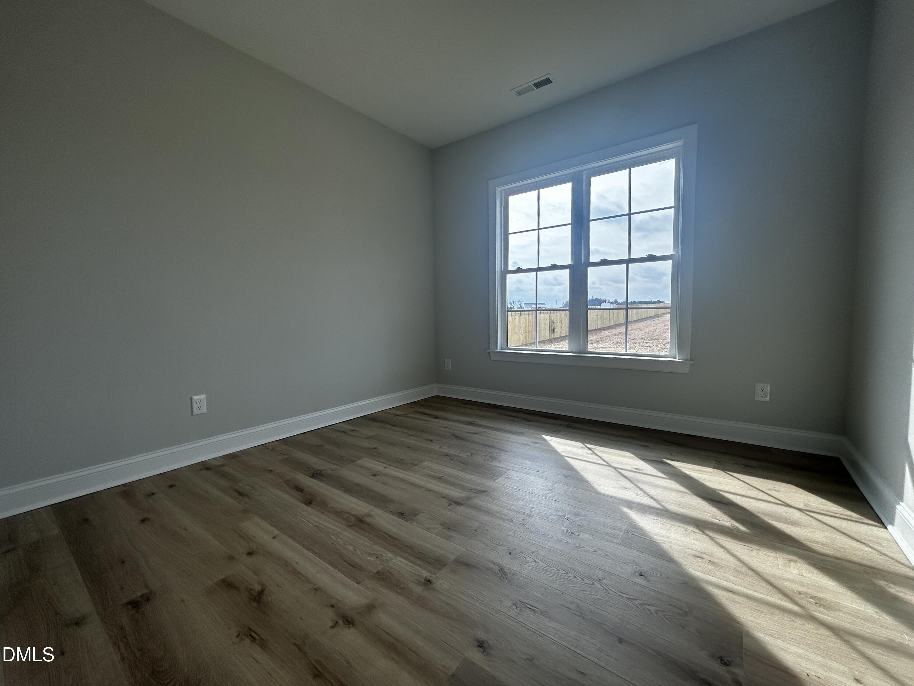 5495 Finch Road Bailey, NC 27880 - Photo 22 of 32 an empty room with wooden floor and windows