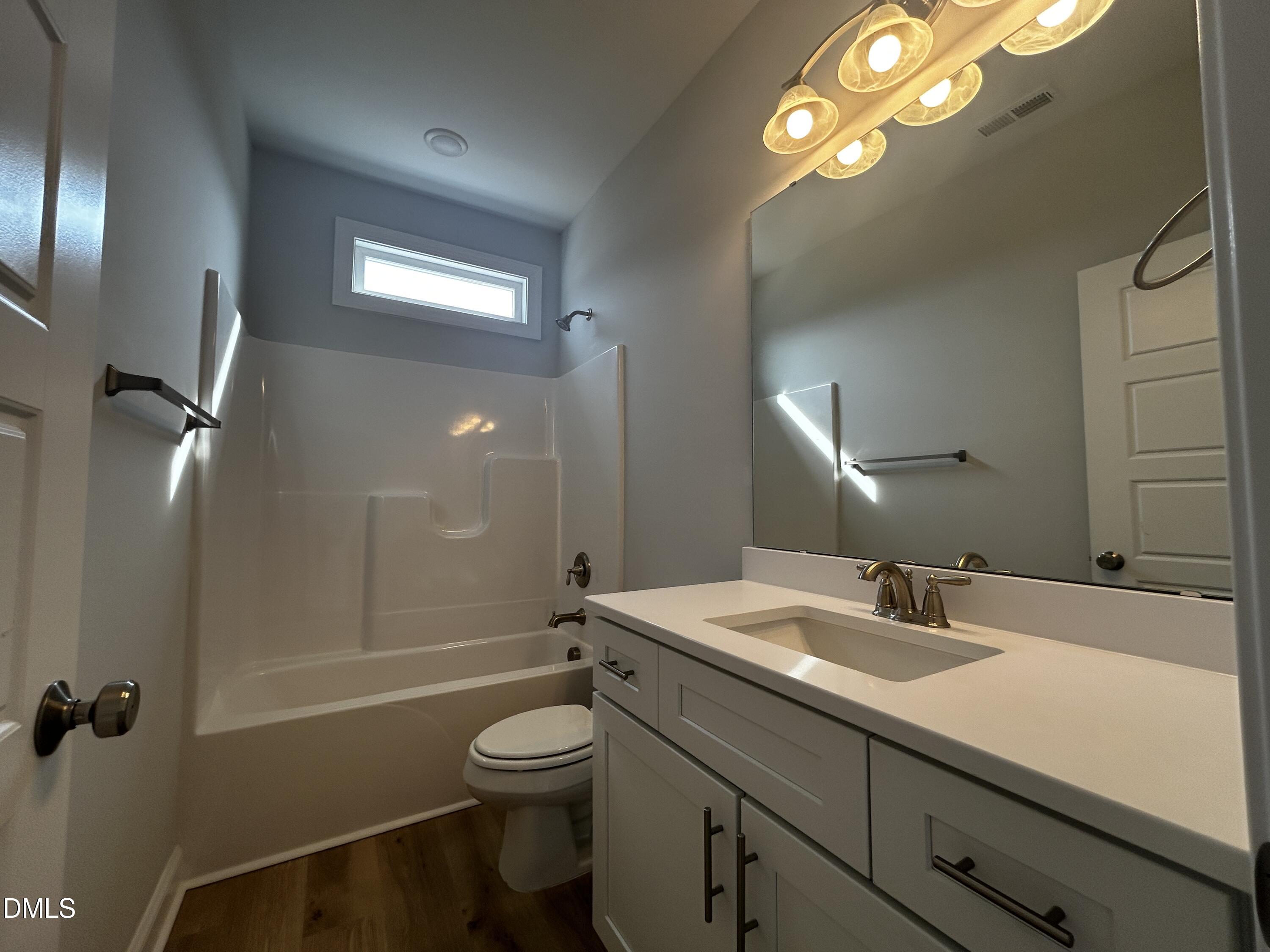 5495 Finch Road Bailey, NC 27880 - Photo 24 of 32 a bathroom with a sink a toilet a mirror and shower