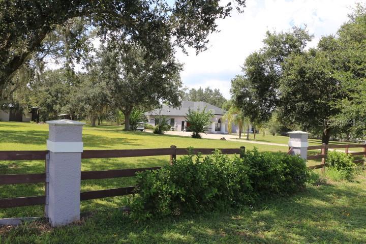 Green Swamp Road Clermont, FL 34714 - Photo 12 of 55 a view of a fountain in a yard with palm trees