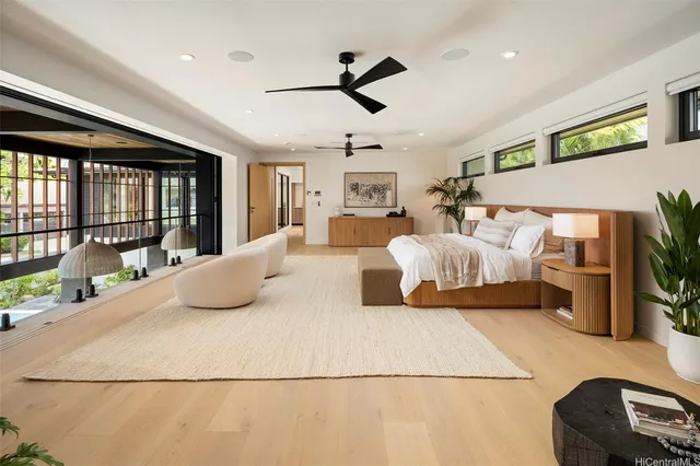 a bedroom with a large bed and a large window