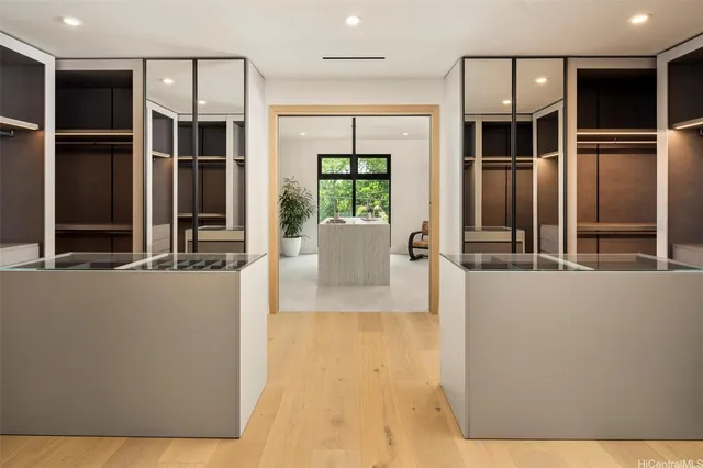 a living room with a large window and chandelier