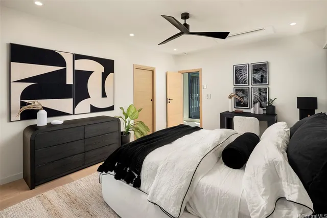 a bedroom with a bed and wooden floor