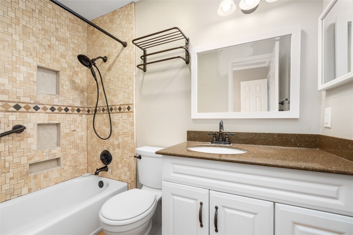 1621 Prairie Mark Lane Houston, TX 77077 - Photo 13 of 26 a bathroom with a granite countertop sink a toilet and shower