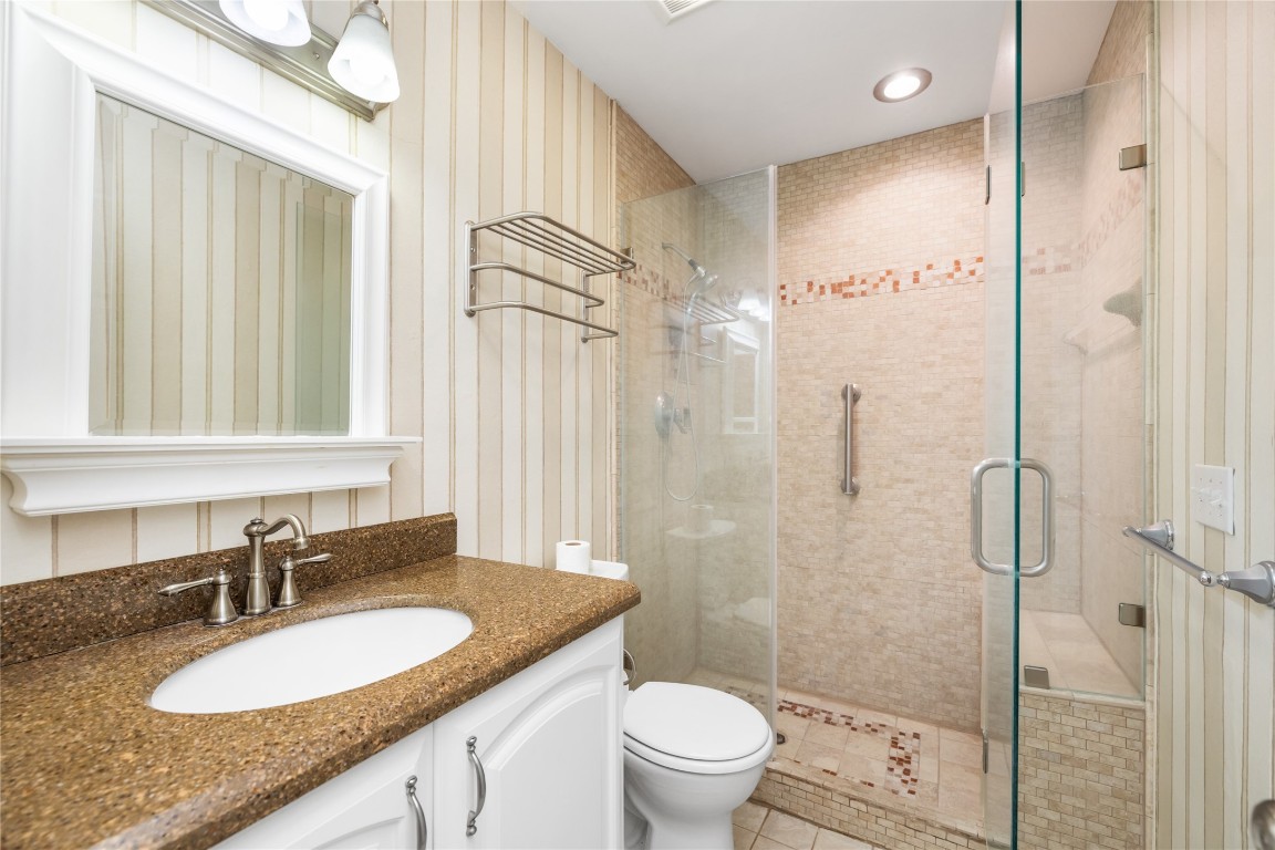 1621 Prairie Mark Lane Houston, TX 77077 - Photo 14 of 26 a bathroom with a granite countertop sink toilet mirror and shower