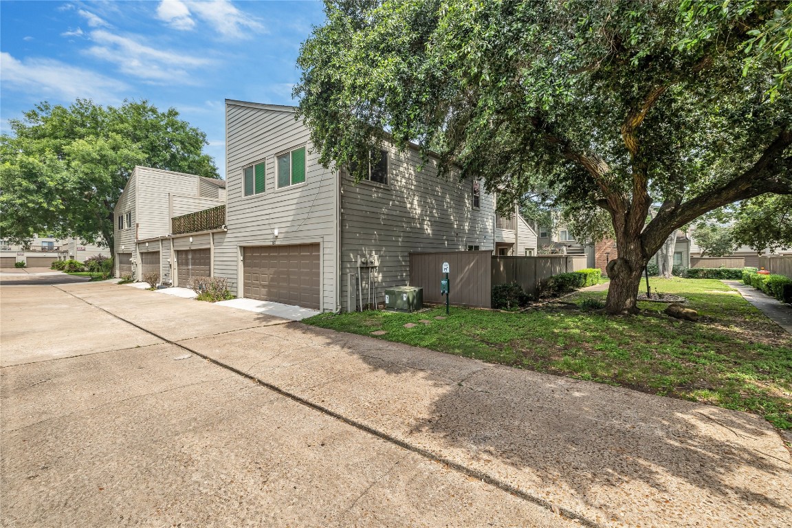 1621 Prairie Mark Lane Houston, TX 77077 - Photo 2 of 26 front view of house with a yard and trees all around