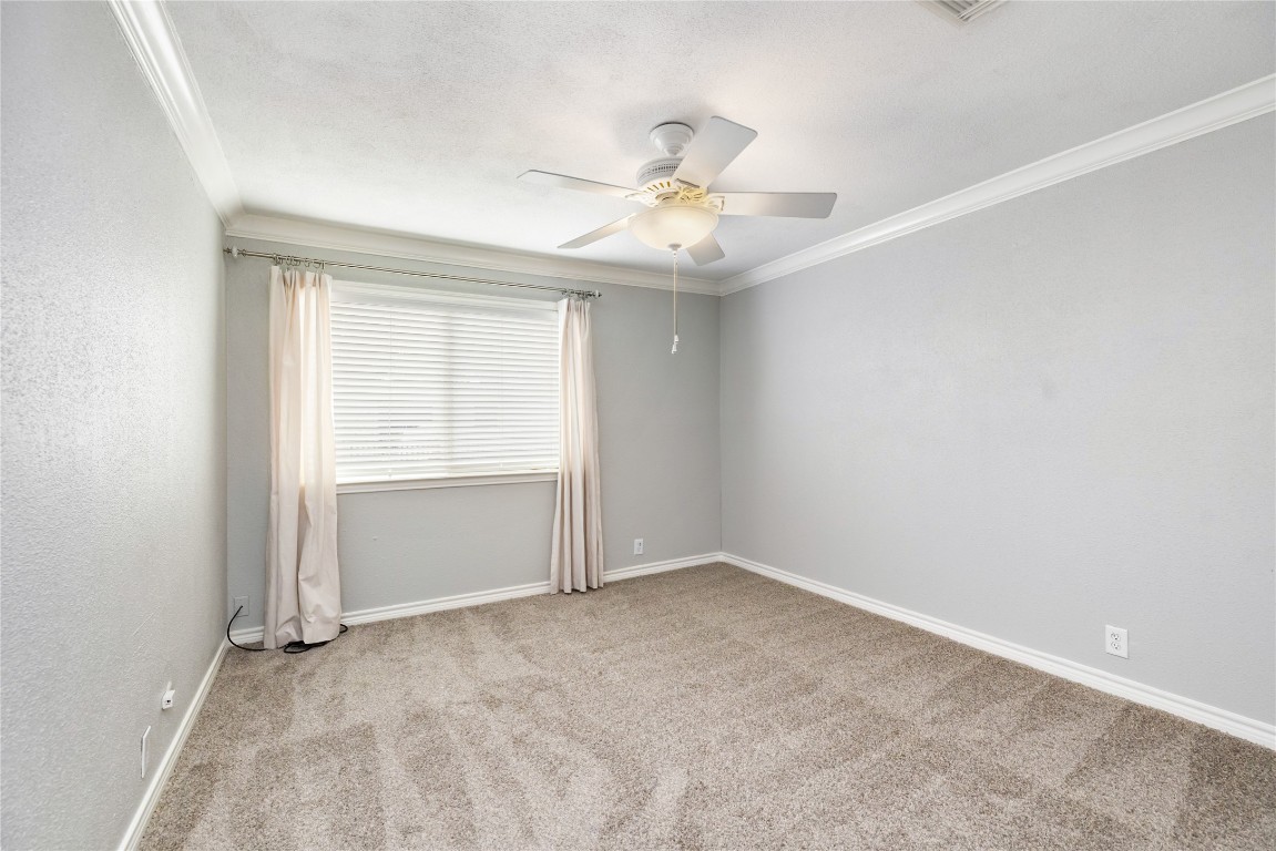 1621 Prairie Mark Lane Houston, TX 77077 - Photo 23 of 26 an empty room with a ceiling fan and a window