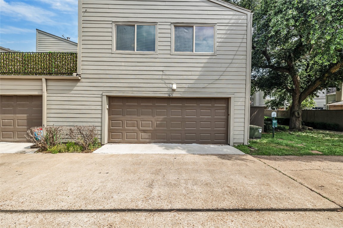 1621 Prairie Mark Lane Houston, TX 77077 - Photo 3 of 26 a front view of a house with a yard and garage